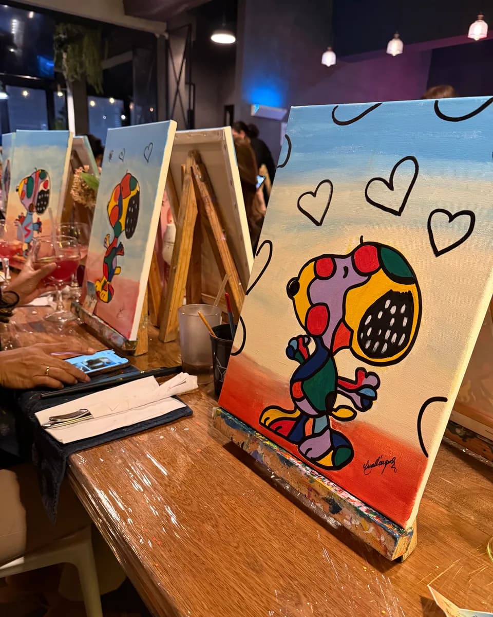 Snoopy-with-hearts canvas on the easel, painted at a Paints & Drinks themed night