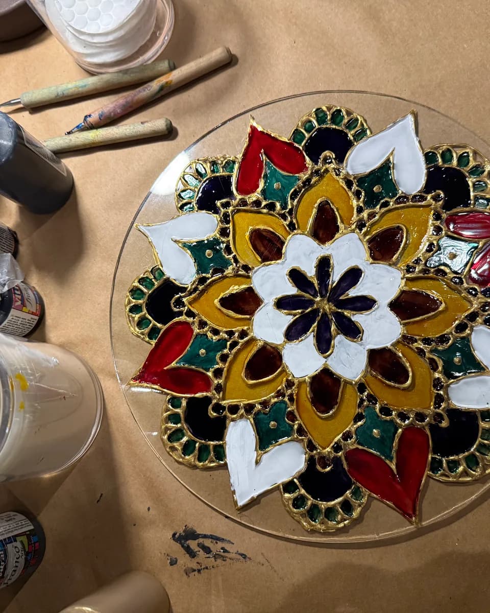 Stained-glass mandala artwork created live at a Paints & Drinks event